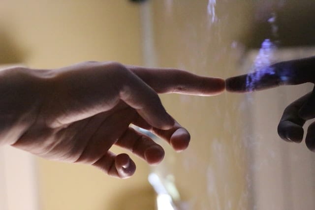 a hand touching a touchscreen