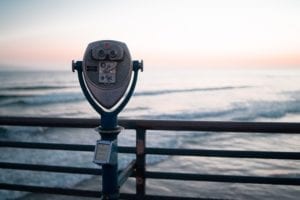 a viewing device overlooking a seaside pier