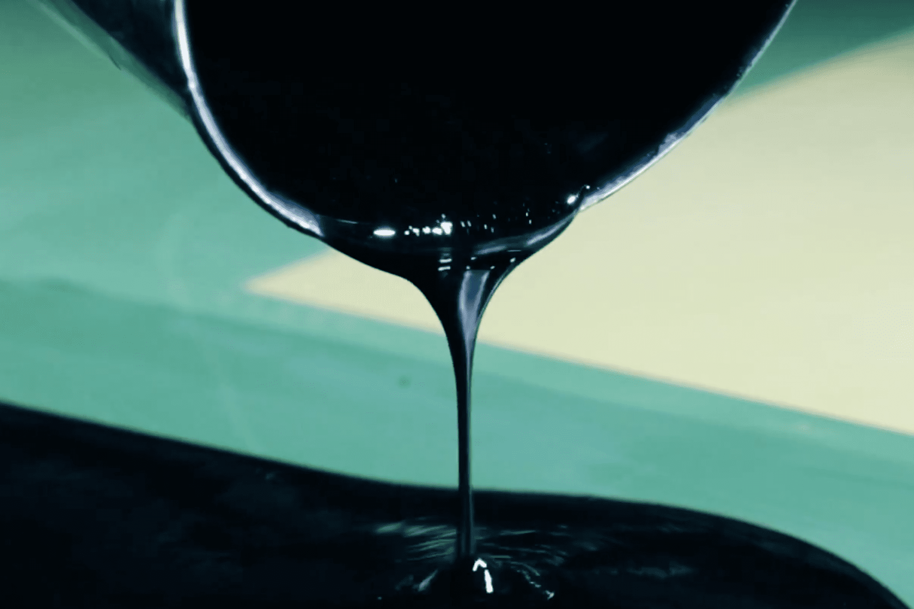 black ink being poured out of a bucket