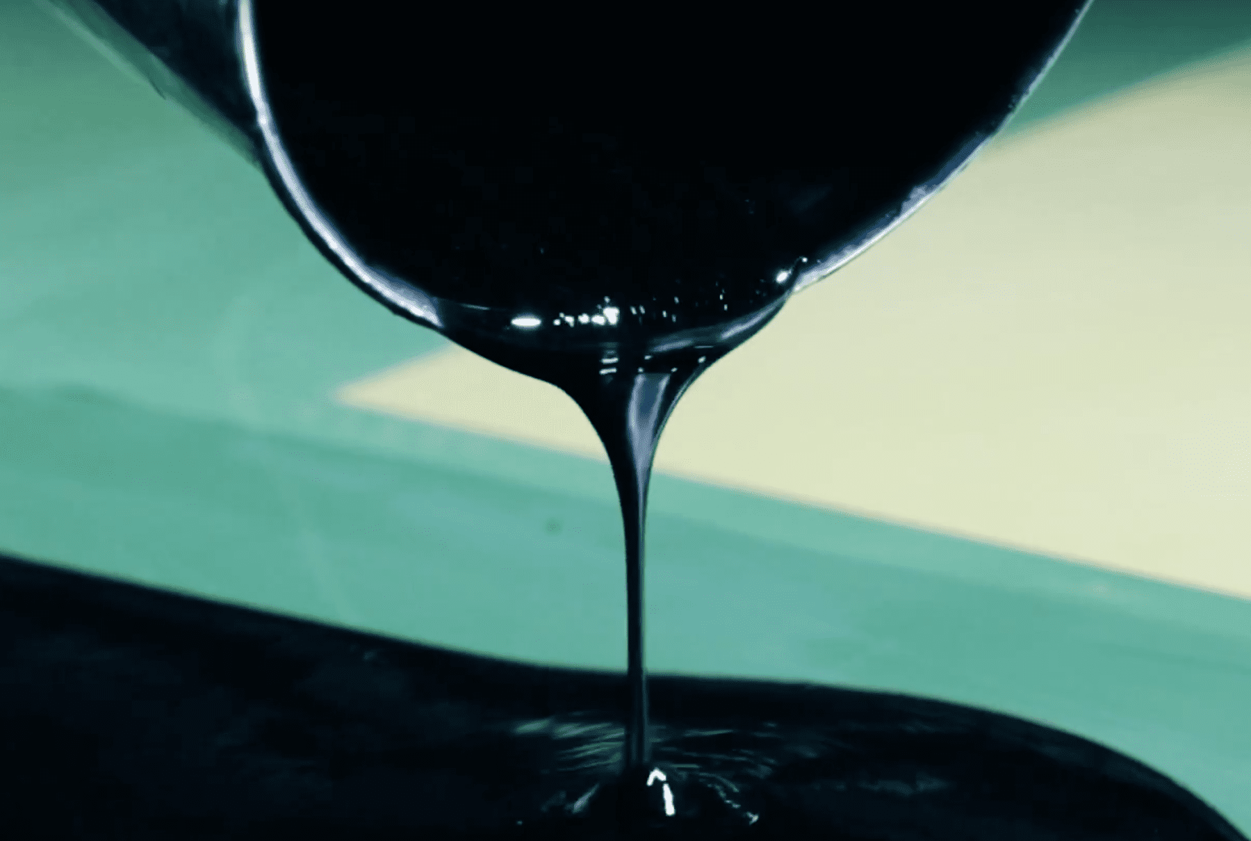 black ink being poured out of a bucket