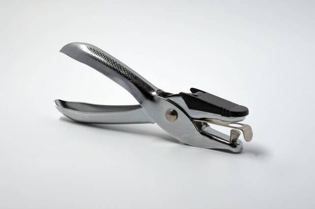 silver handheld holepunch