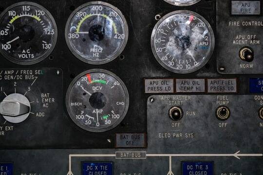 numerous round display gauges on a black control panel