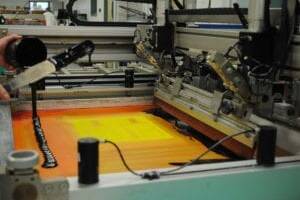 printing press creating an orange-colored printed technology