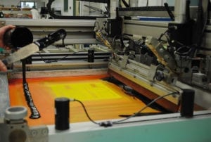 printing press creating an orange-colored printed technology