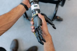 human hand shaking hands with a robotic hand