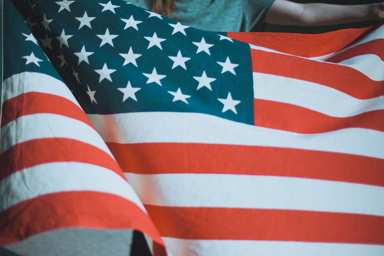 an American flag being held and waving