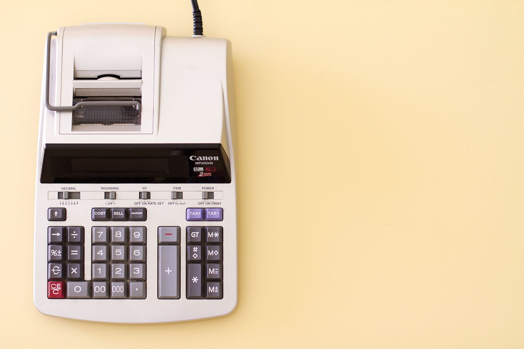 an older model of a calculator that has a receipt-printing option