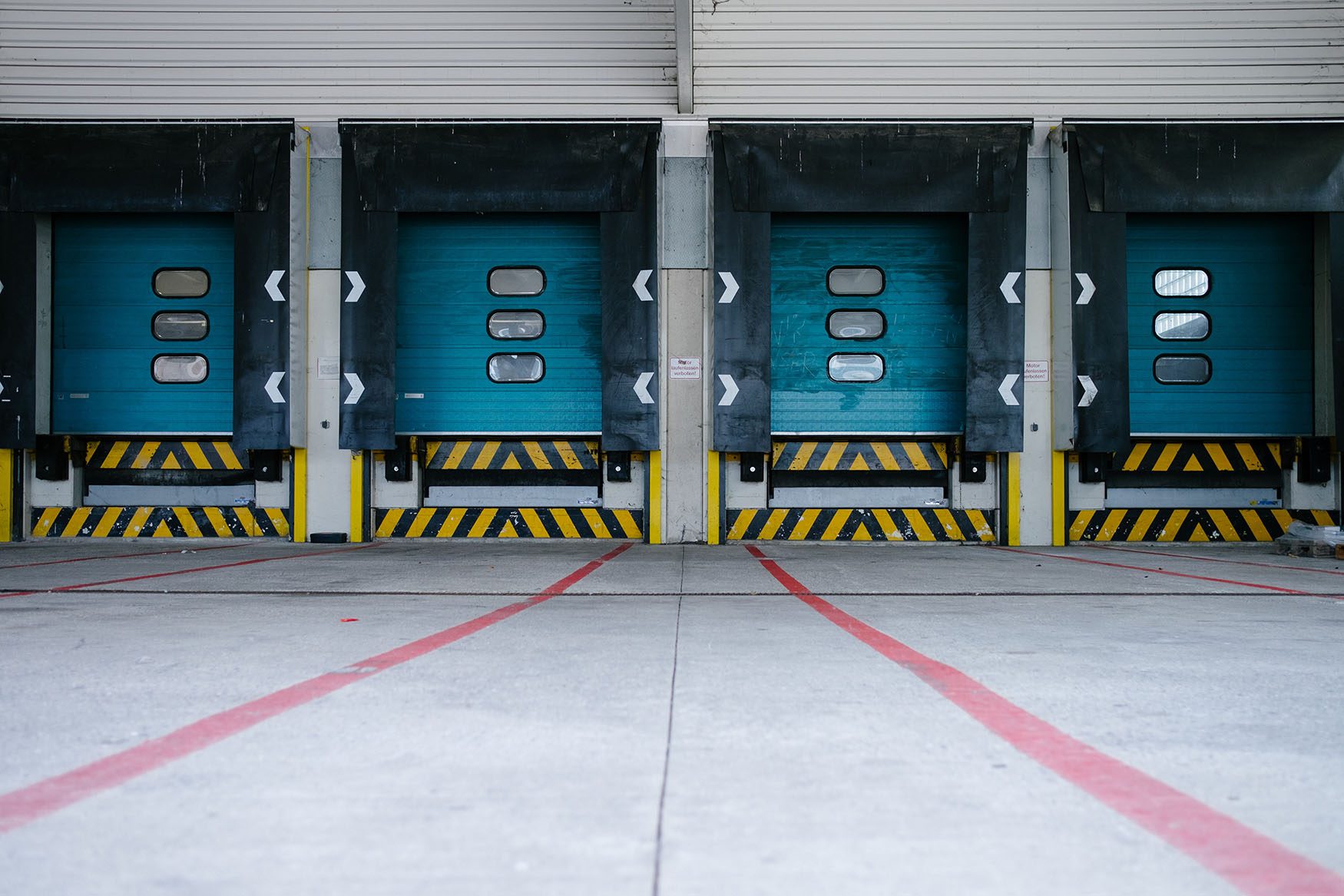 four empty truck bays in a shipping dock