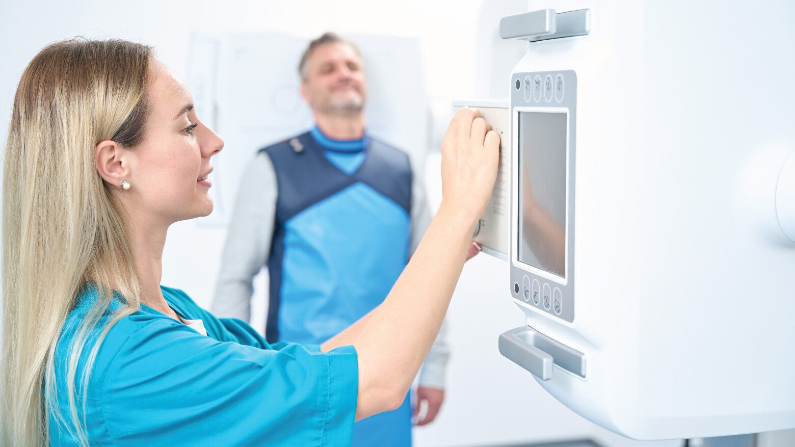 Woman in a medical clinic looking at a touchscreen-based equipment