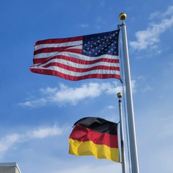 American and German flags blowing in the wind