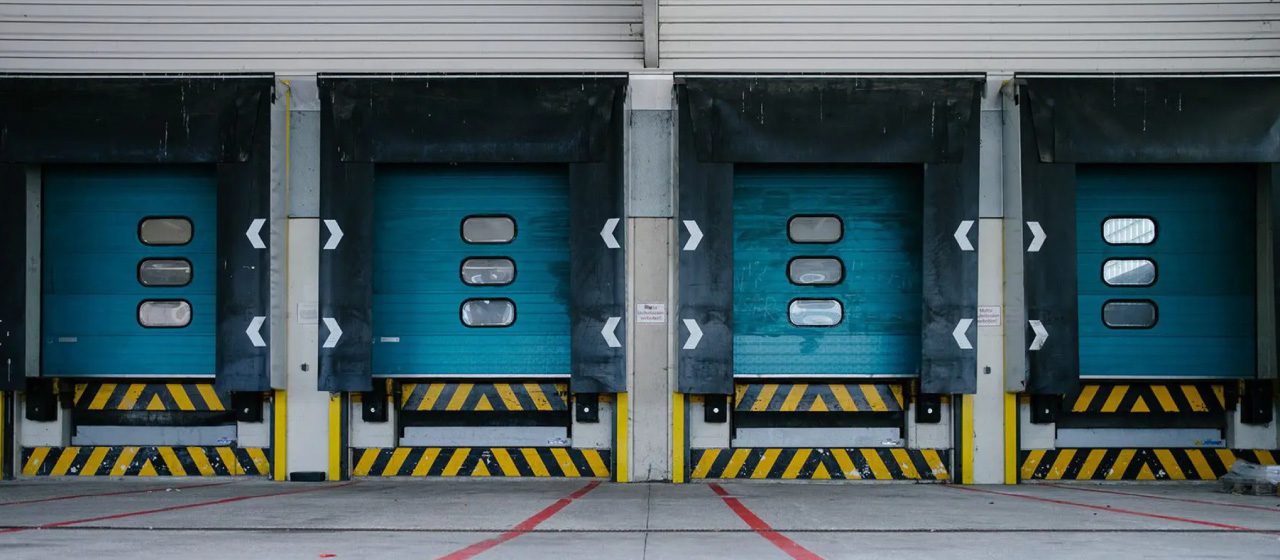 four empty truck bays in a shipping department